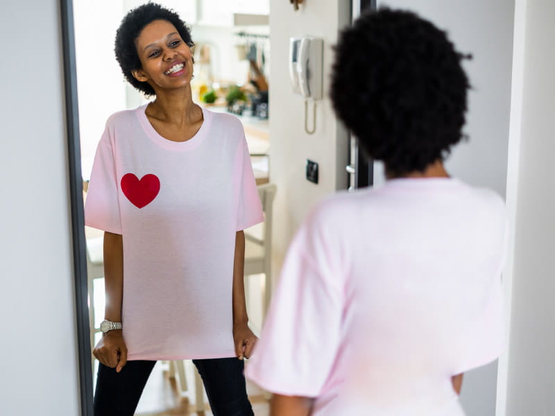 Woman looking in the mirror and smiling