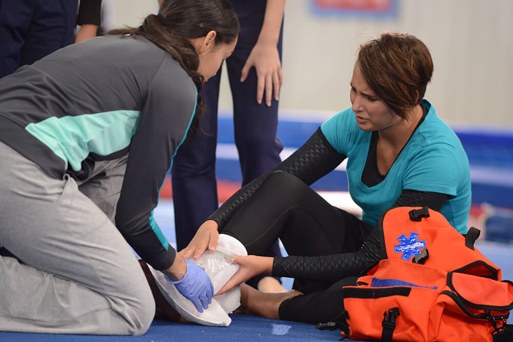 一名妇女正在进行脚踝受伤的急救