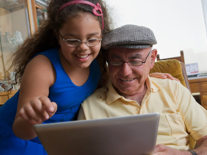 HIspanic man and child reading tablet